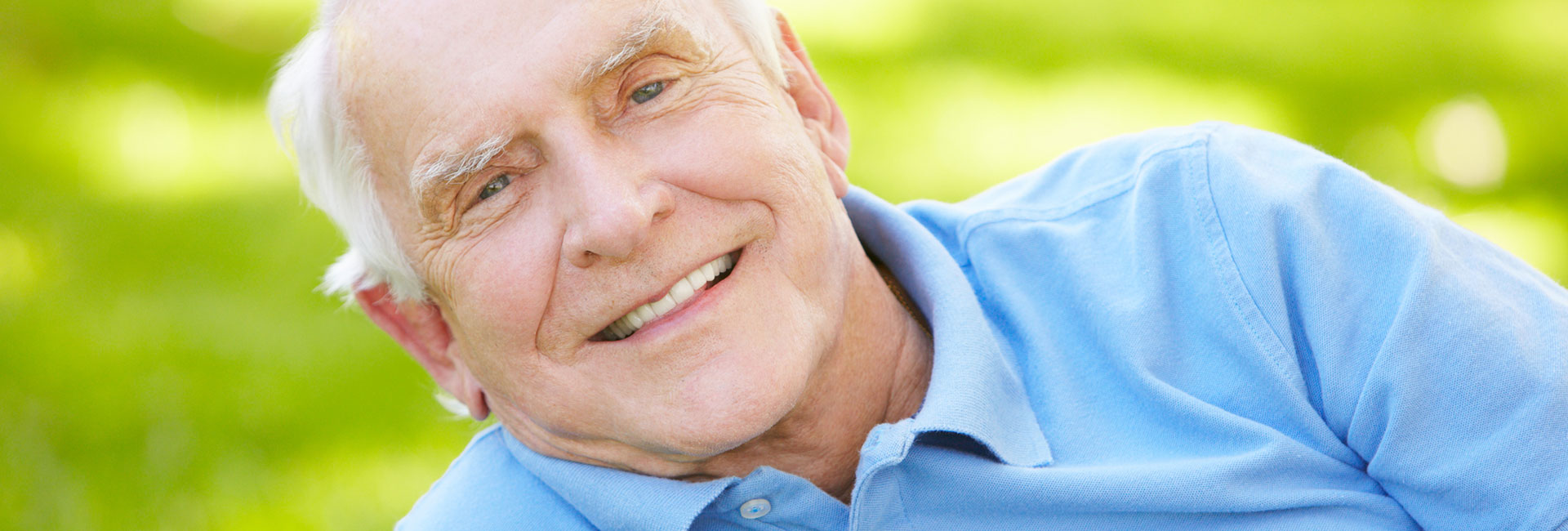 Senior man smiling after gum disease treatment
