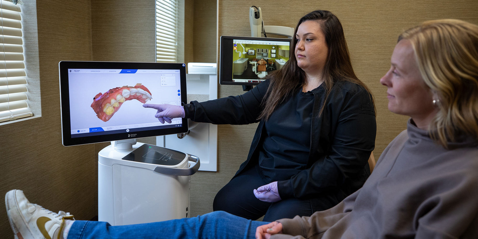 Team member and Patient looking at a dental scan of Patients teeth
